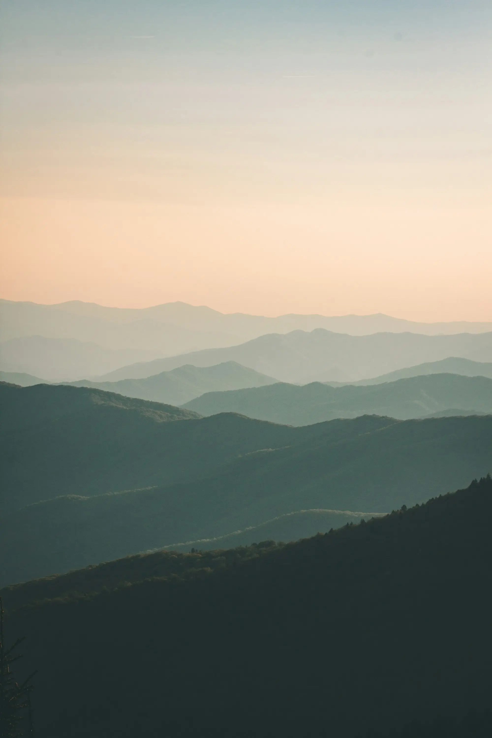 Successive ridgelines fading into haze.